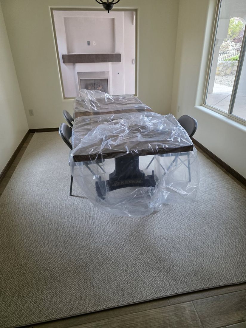 Dining table and chairs still wrapped in plastic after delivery