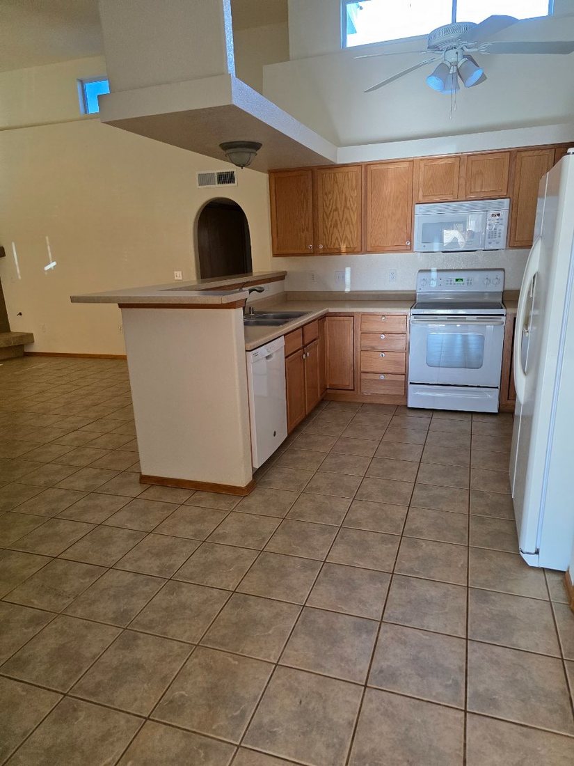 Empty kitchen and breakfast bar before staging furniture arrives