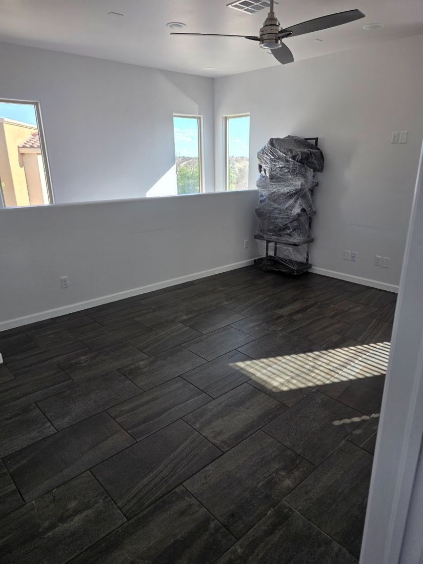 Empty loft with one wrapped piece waiting to be staged