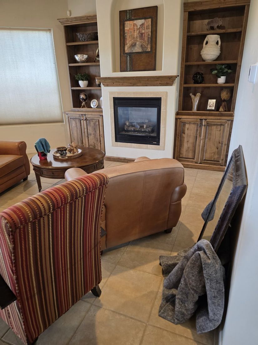 Living room staging in progress with blankets and art waiting