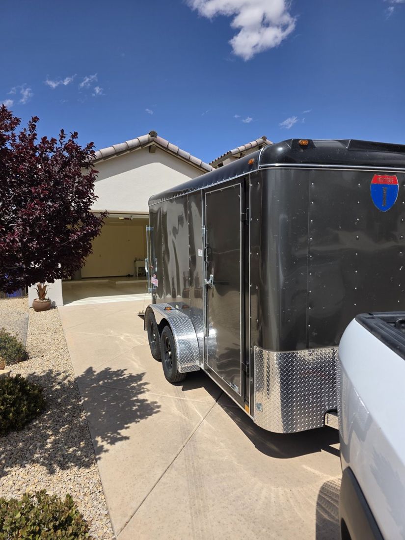 Enclosed staging trailer and pickup truck at a Las Cruces home