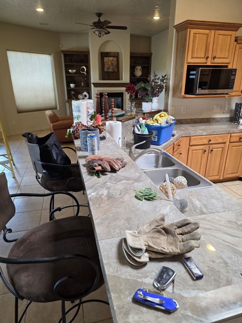 Gloves, tools and décor on the kitchen counter during staging