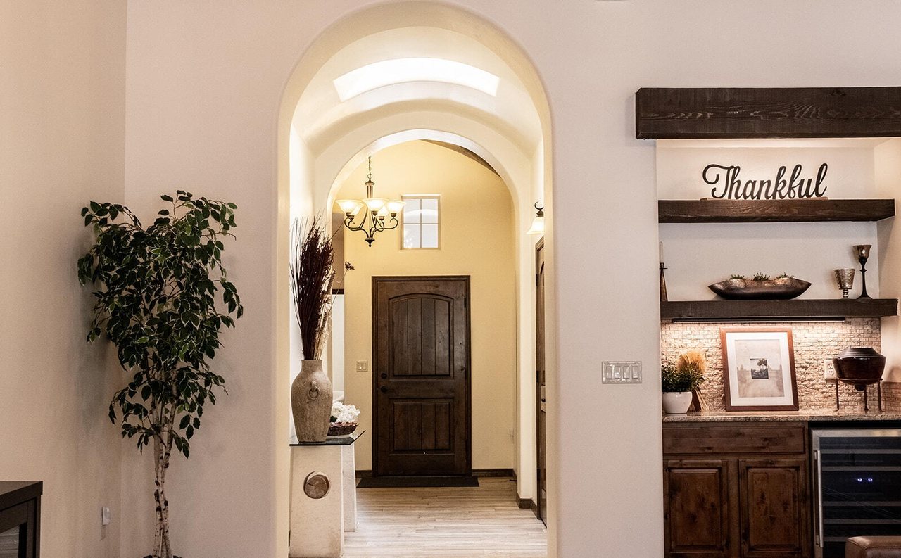 Finished entry with arched hallway, plant and styled shelves, Sedona Boulders Las Cruces