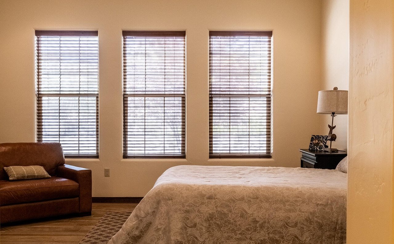Finished staged guest bedroom with real bed and loveseat, Sedona Boulders
